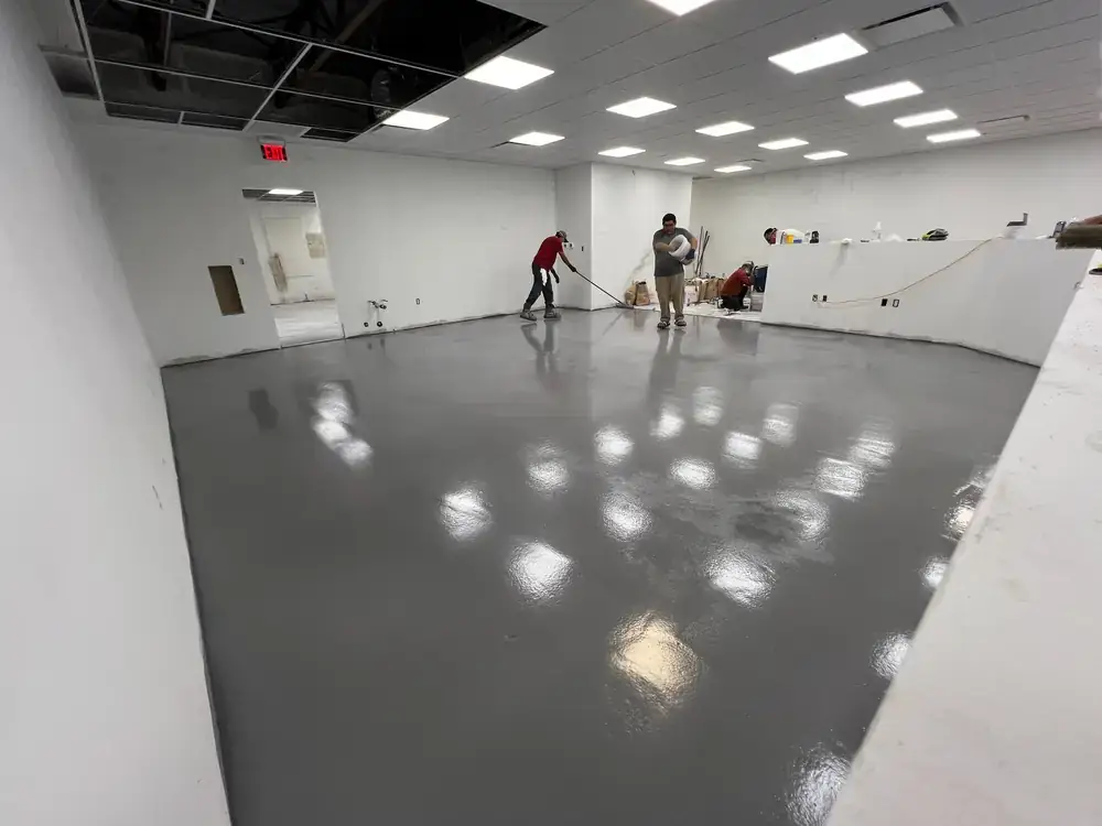 Crew installing gray resinous flooring